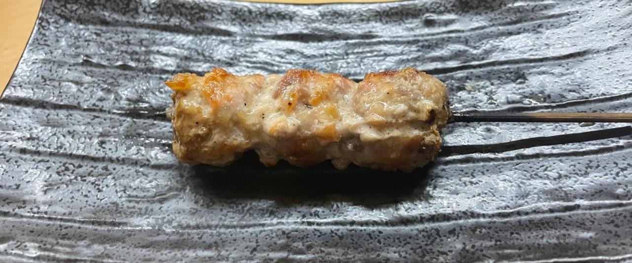 黒い皿にのったつくねの串